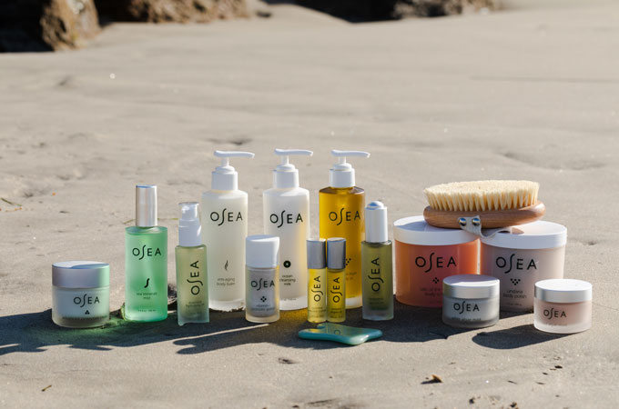 OSEA Malibu Product Collection displayed on sandy beach