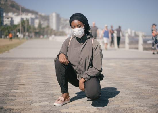 ethnic-female-in-outerwear-and-protective-mask-squatting-on-4177646 ethnic-female-in-outerwear-and-protective-mask-squatting-on-4177646