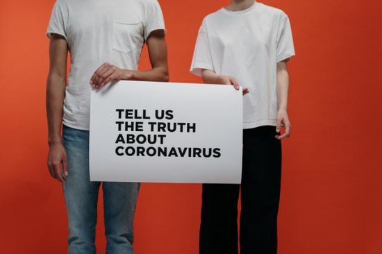 people-holding-a-poster-asking-about-facts-on-coronavirus-3952215