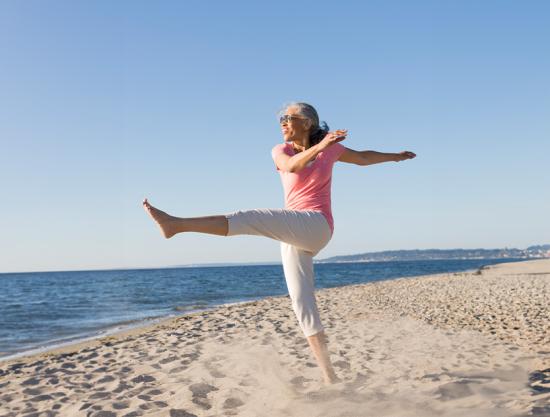 woman-kicking-up-sand-at-the-beach